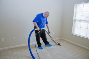 man cleaning a floor