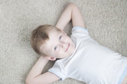 boy sleeping on carpet