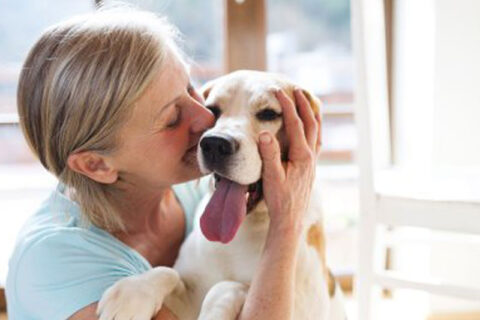 women kissing dog