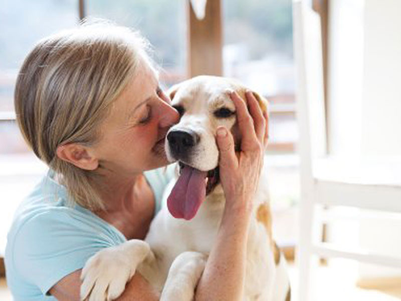 women kissing dog